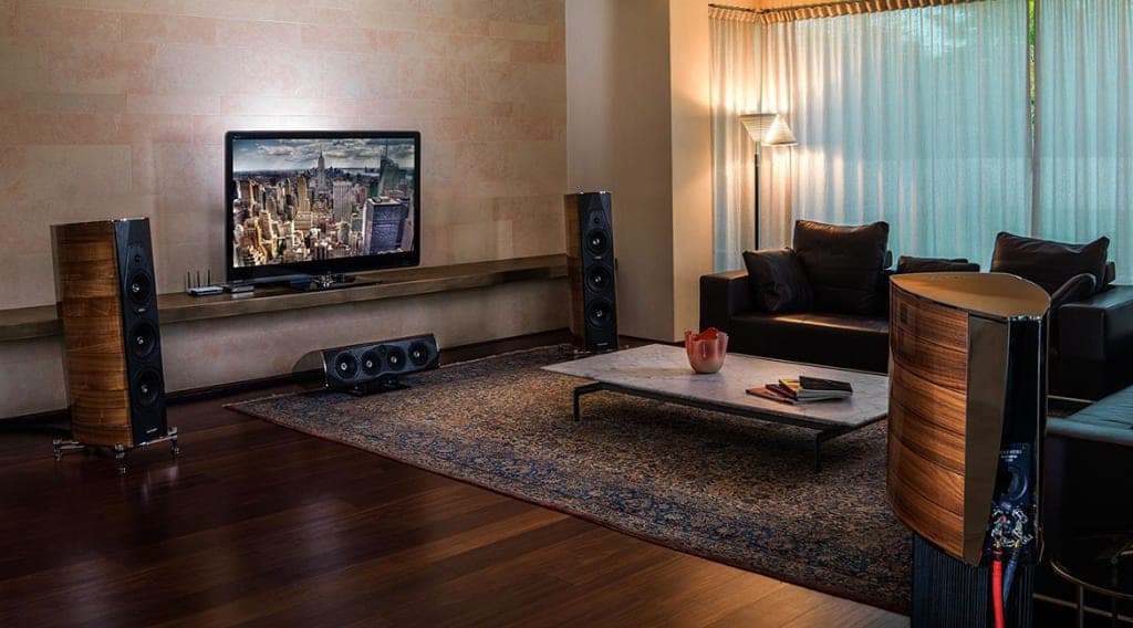 Living room with a set of speakers around the couch