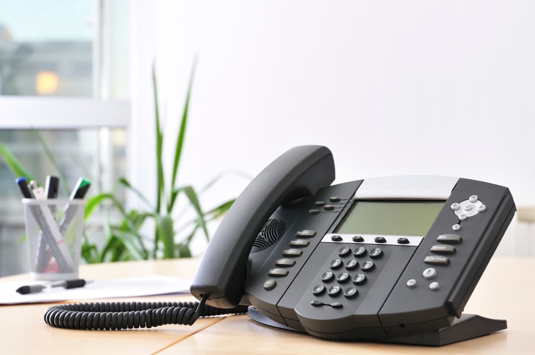 Office phone sitting on desk